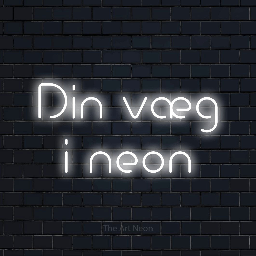 Personligt neonskilt med teksten “Din væg i neon” på en sort murstensvæg