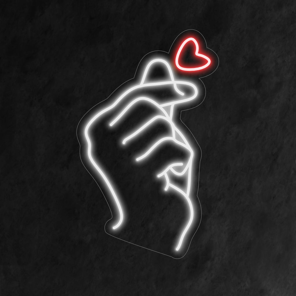 "Finger Heart Neon Sign" svítí s láskou, ideální pro prostory, které zahrnují pozitivitu a hřejivé gesto prstového srdce, které dodává atmosféře roztomilý nádech.