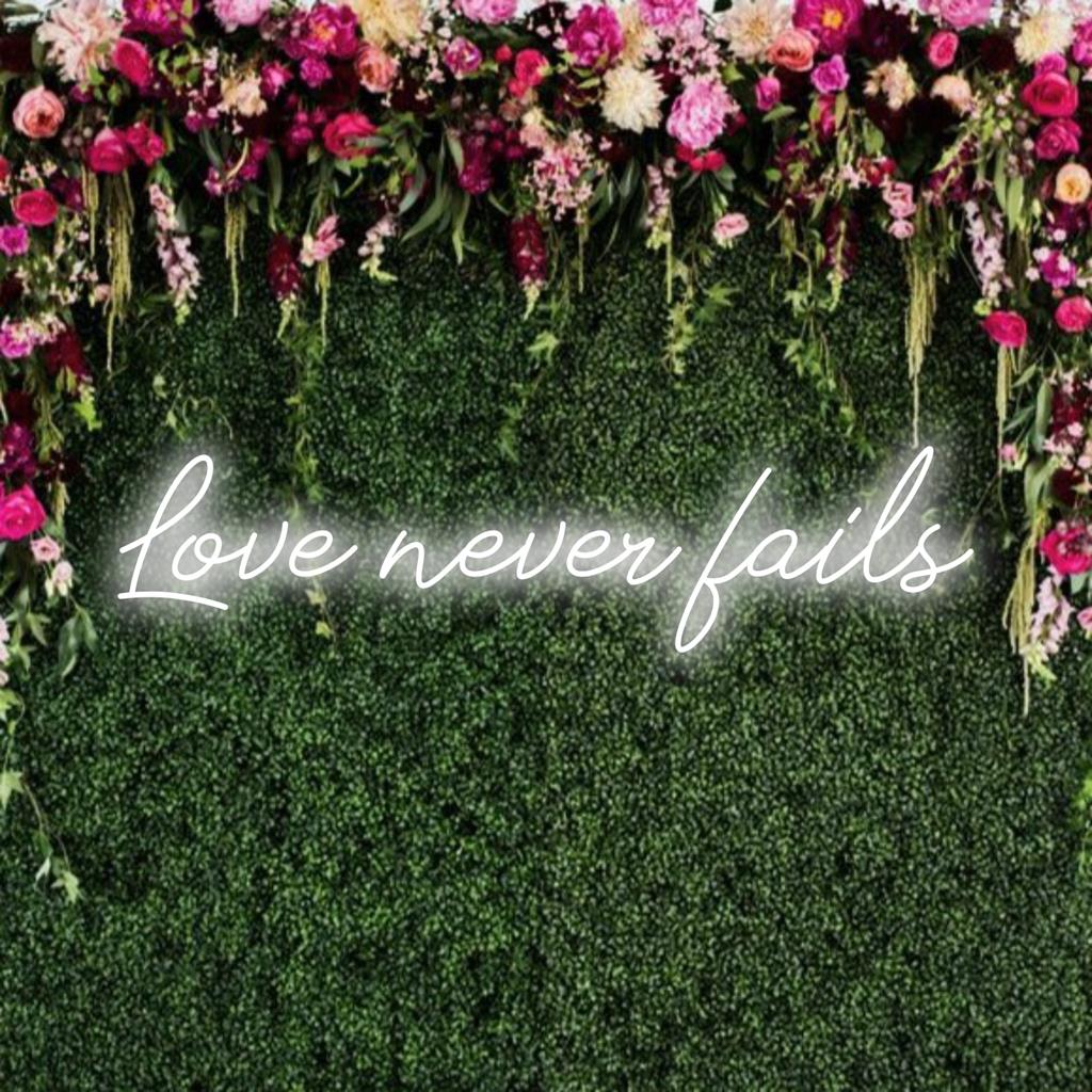 LED neon sign featuring Love Never Fails in radiant colors; perfect for ambience and expressing eternal love.