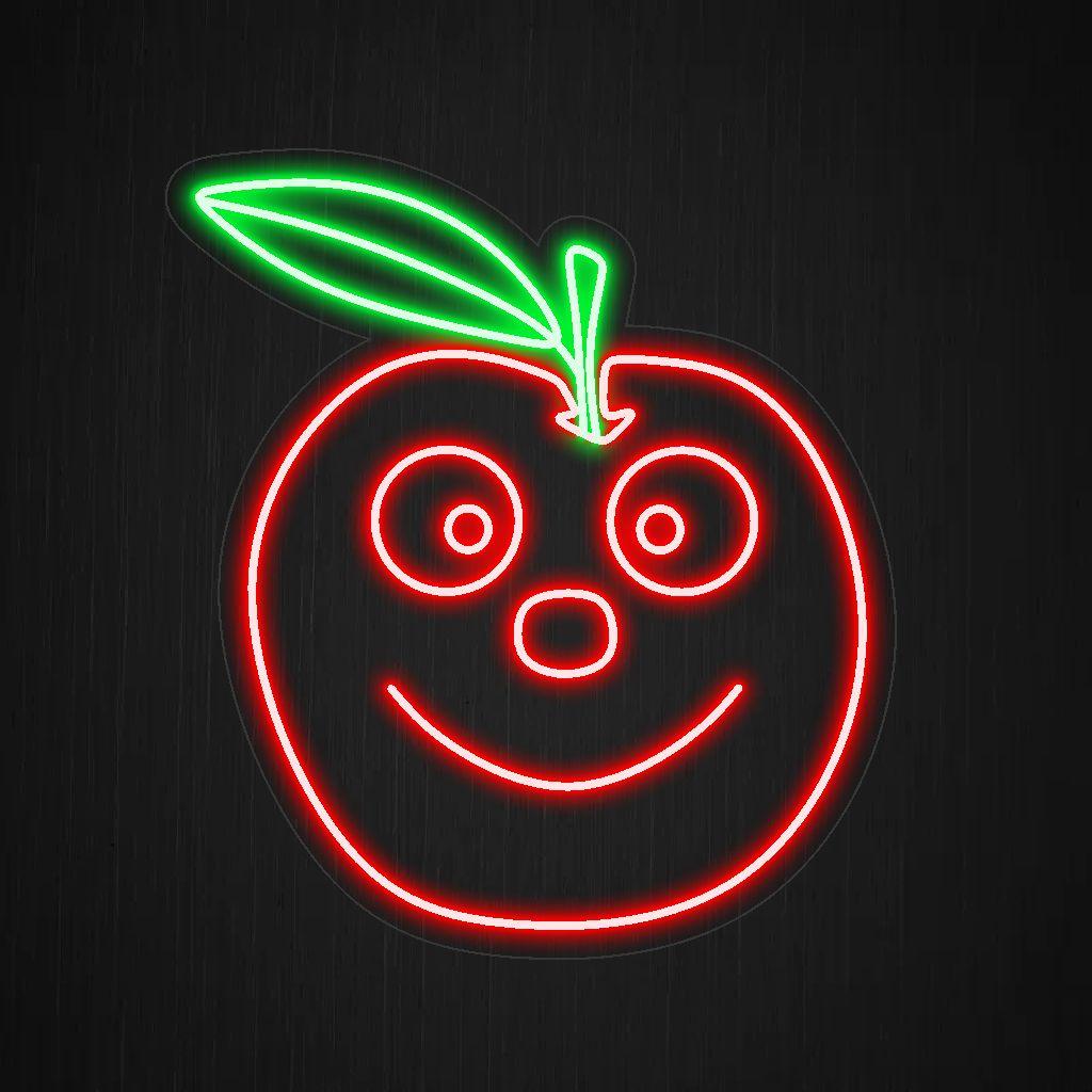 Un'insegna al neon illuminata raffigurante una mela sorridente, che emana felicità e aggiunge un tocco di delizia fruttata a qualsiasi spazio