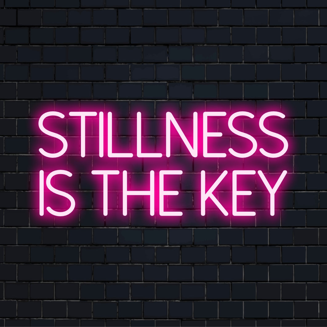 Custom LED neon sign showcasing the words Stillness Is the Key, perfect for personalized neon wall art or inspirational decor.