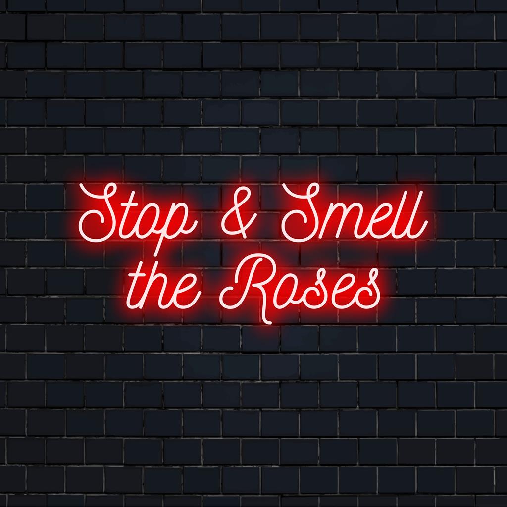 Custom LED neon sign with Stop And Smell The Roses phrase; perfect neon light decor for any space.