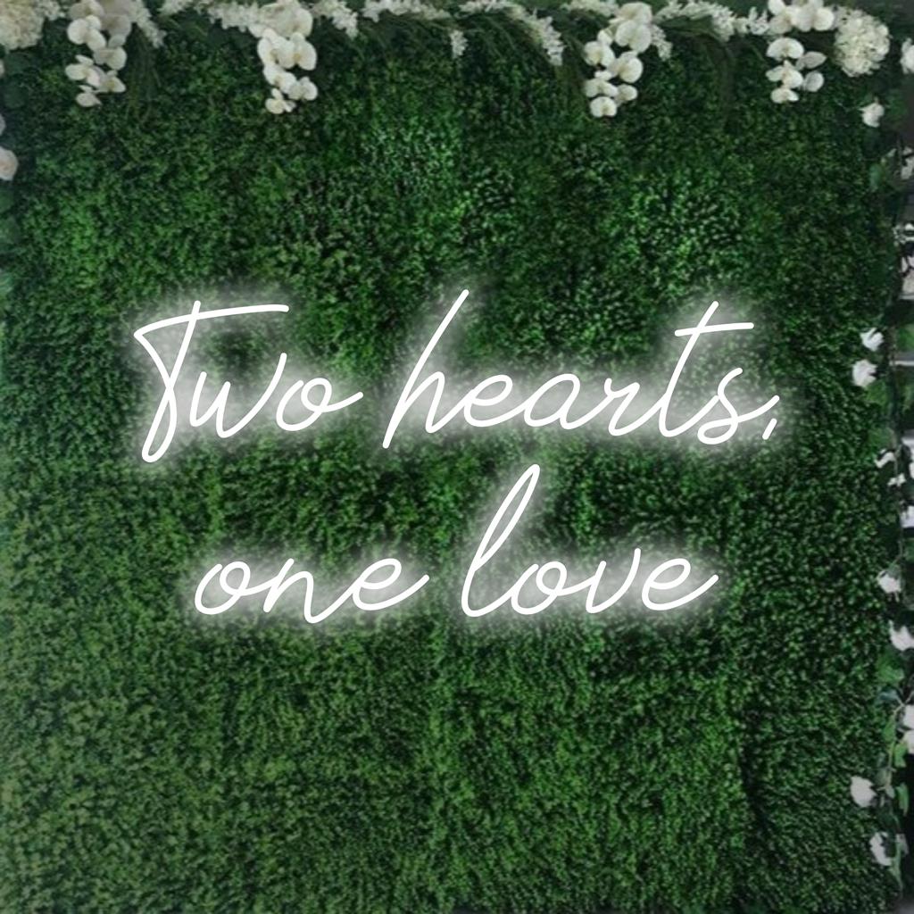 Custom LED neon sign depicting two intertwined hearts with the phrase One Love in elegant script; neon wall art.