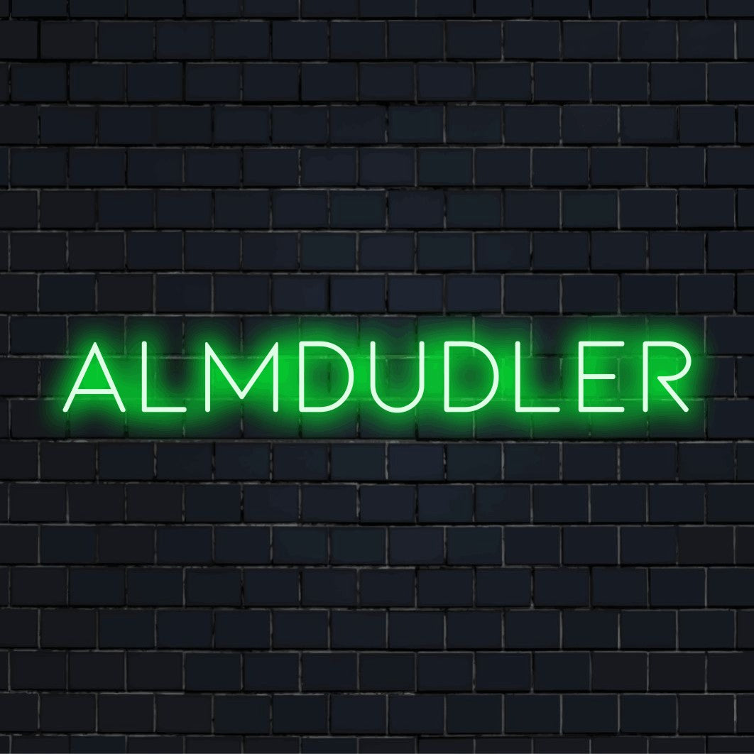 Almdudler Neon Light with glowing lettering against black brick wall
