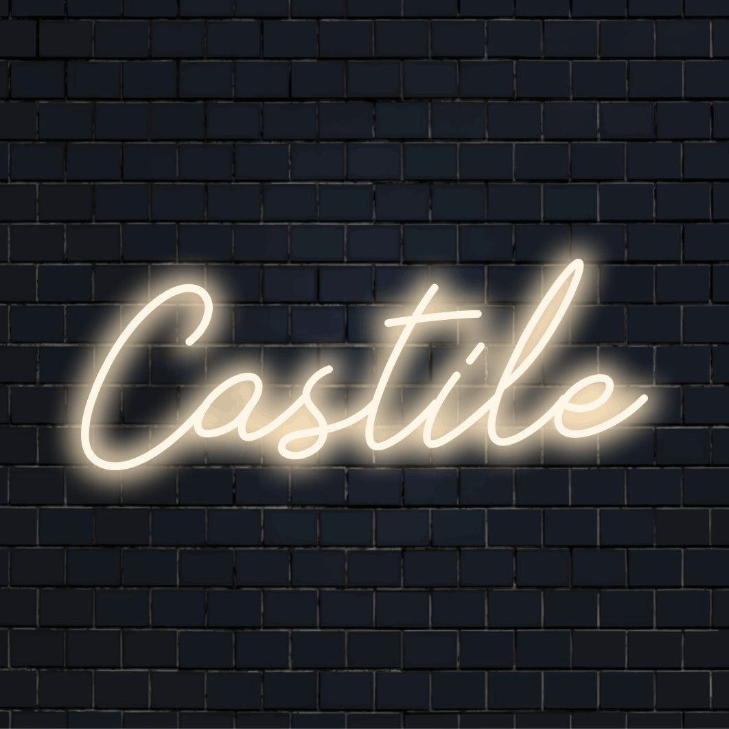 Castile Neon Sign, bright neon lettering against brick backdrop