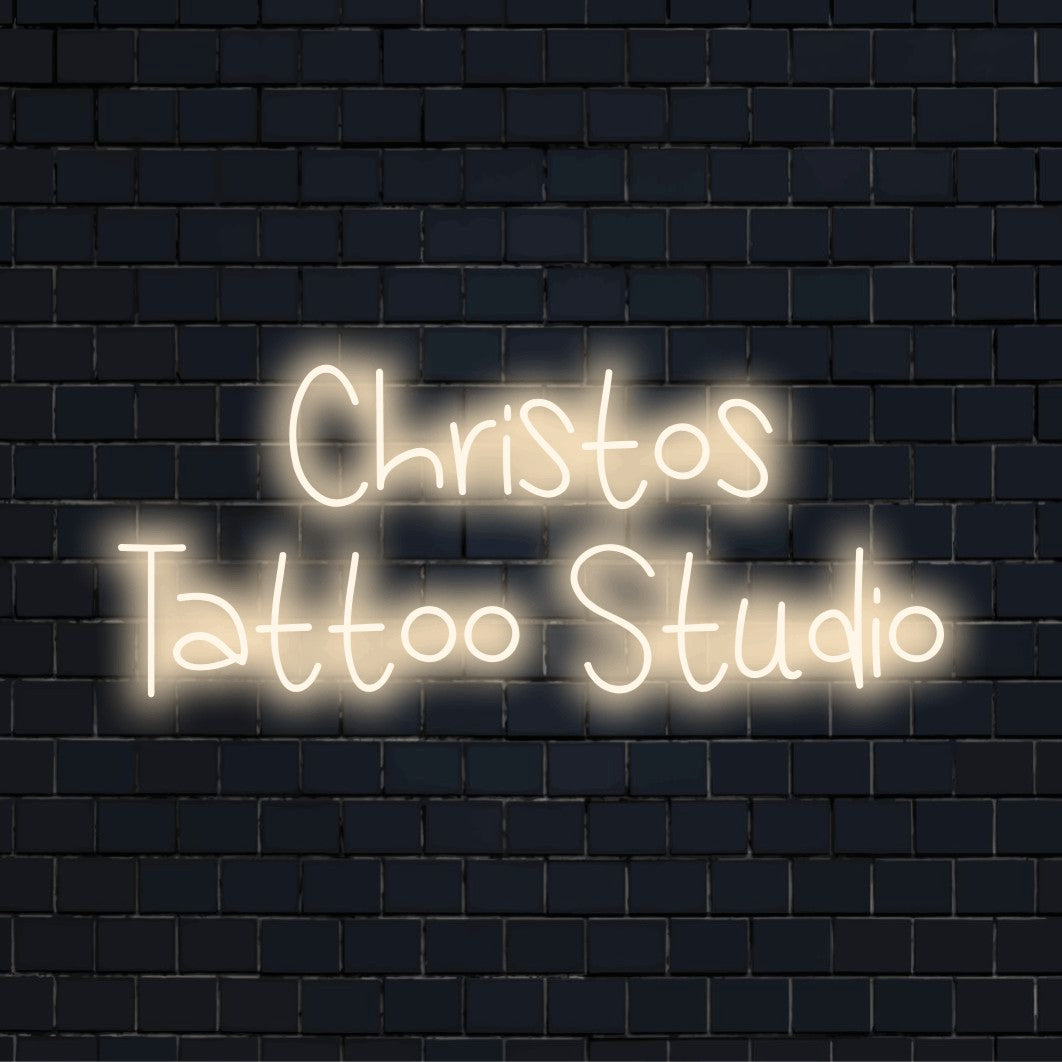 Christos Tattoo Studio Personalized Neon Light with bright neon glow on dark brick wall