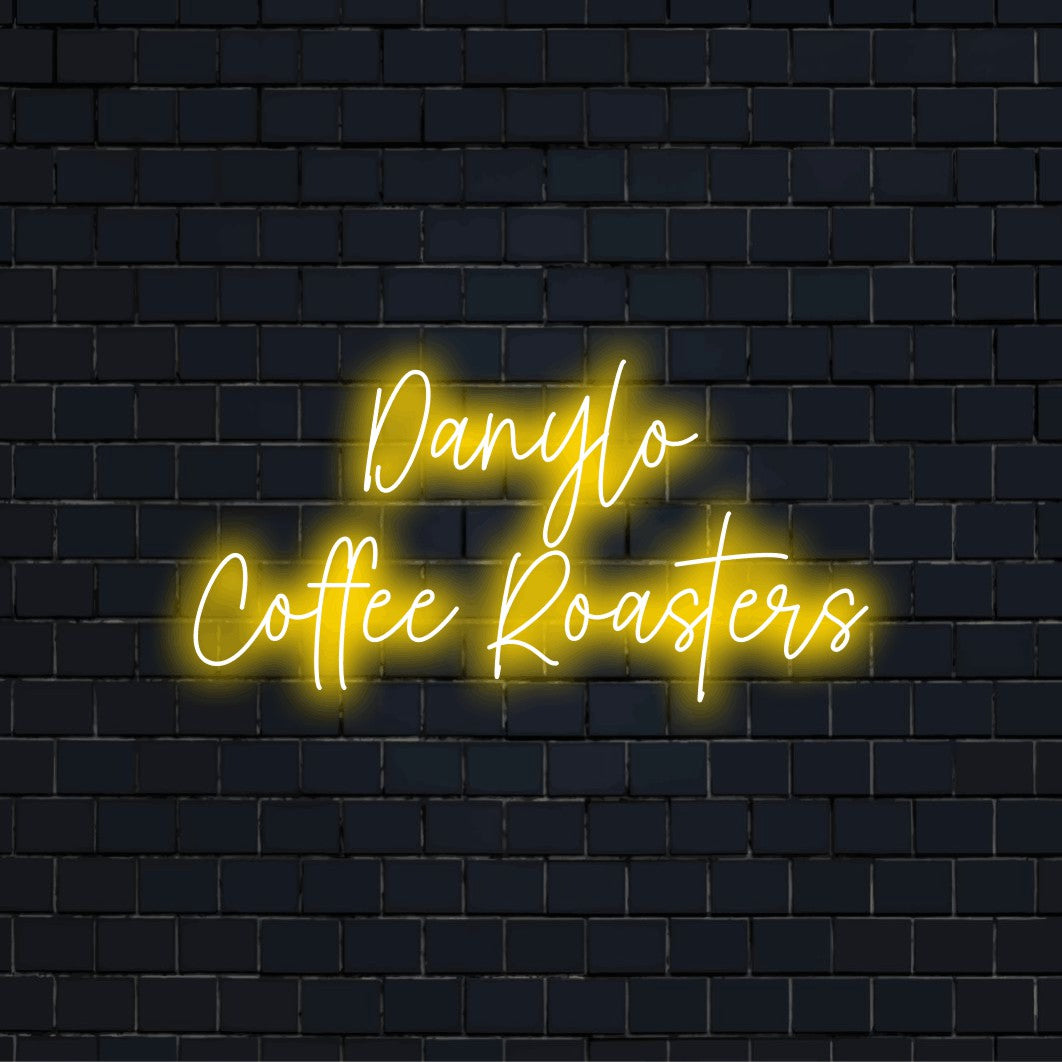 Danylo Coffee Roasters Custom Name Neon Sign, neon text light on dark brick background