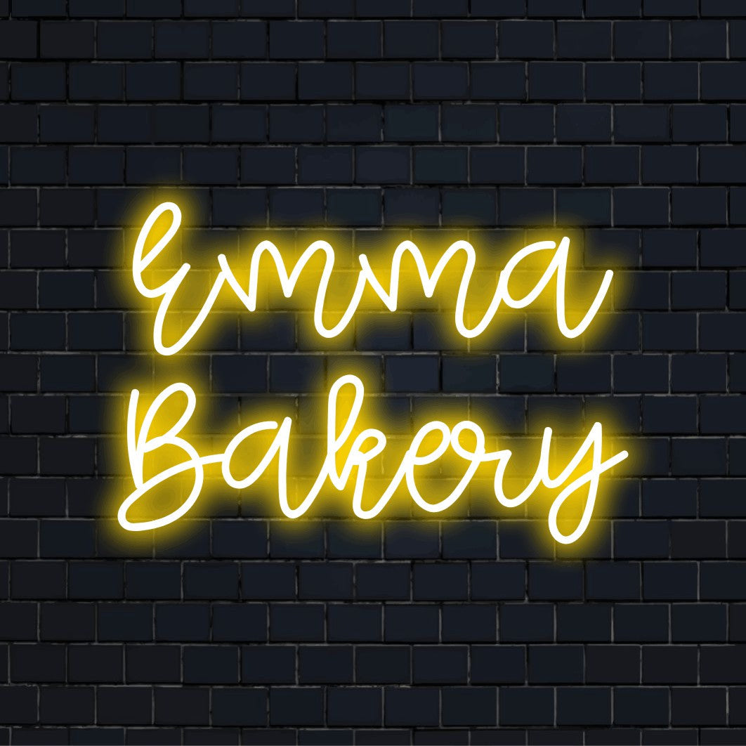 Emma Bakery Custom Name Neon Sign, glowing wall decor on dark brick wall