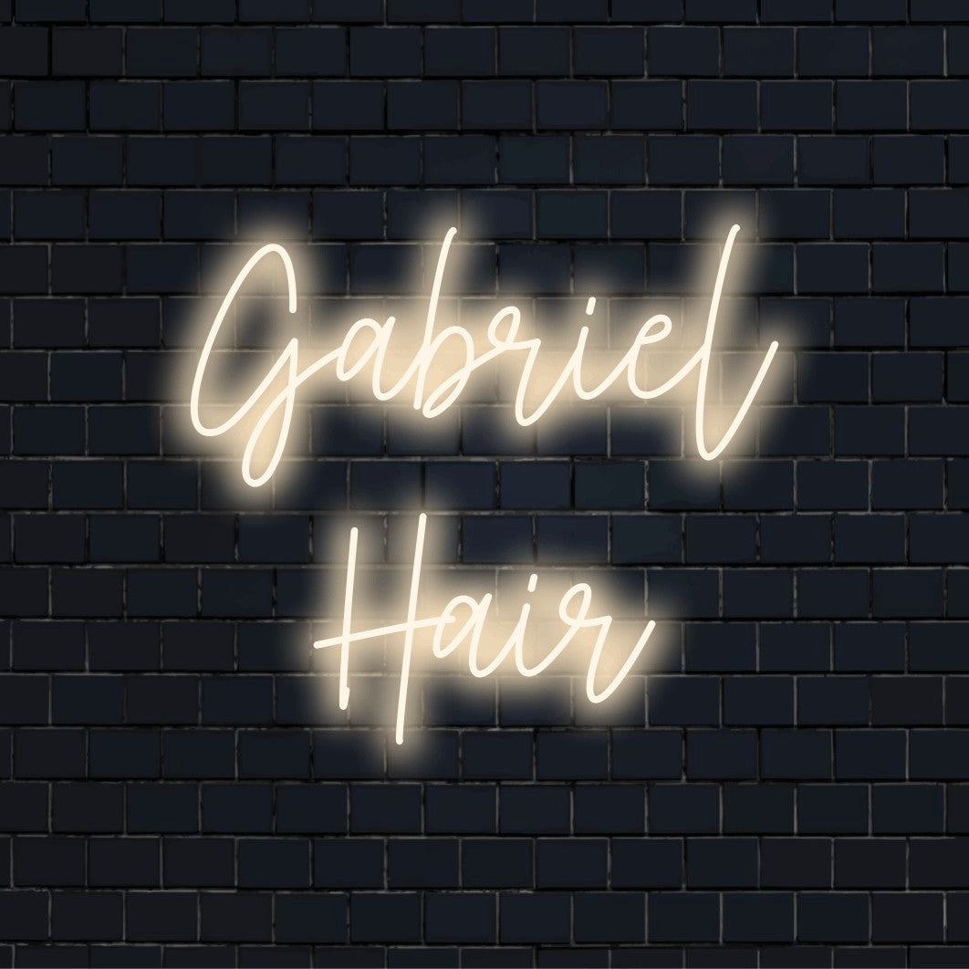 Gabriel Hair Custom Name Neon Sign, bright neon glow on dark brick wall