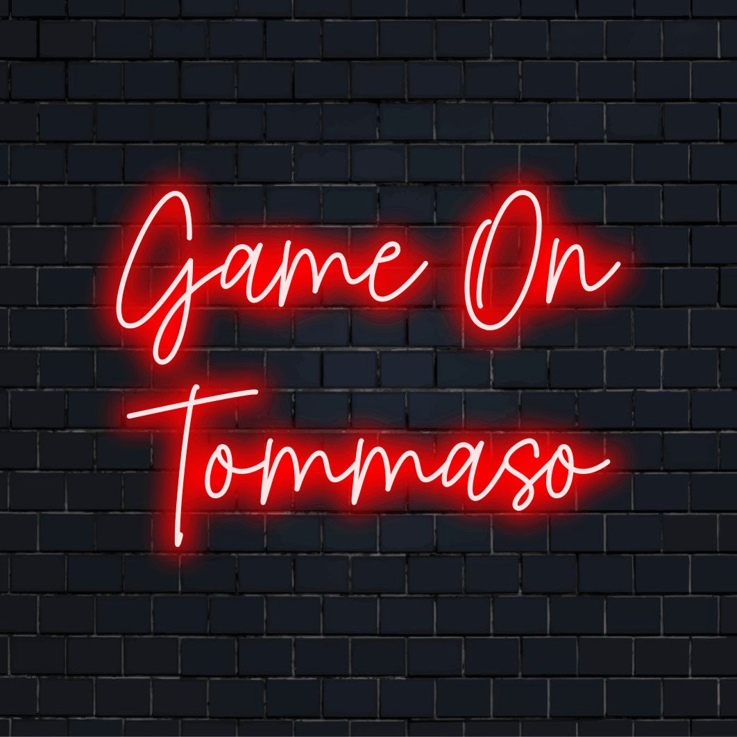 Game On Tommaso Personalized LED Neon Sign, glowing lettering against brick backdrop