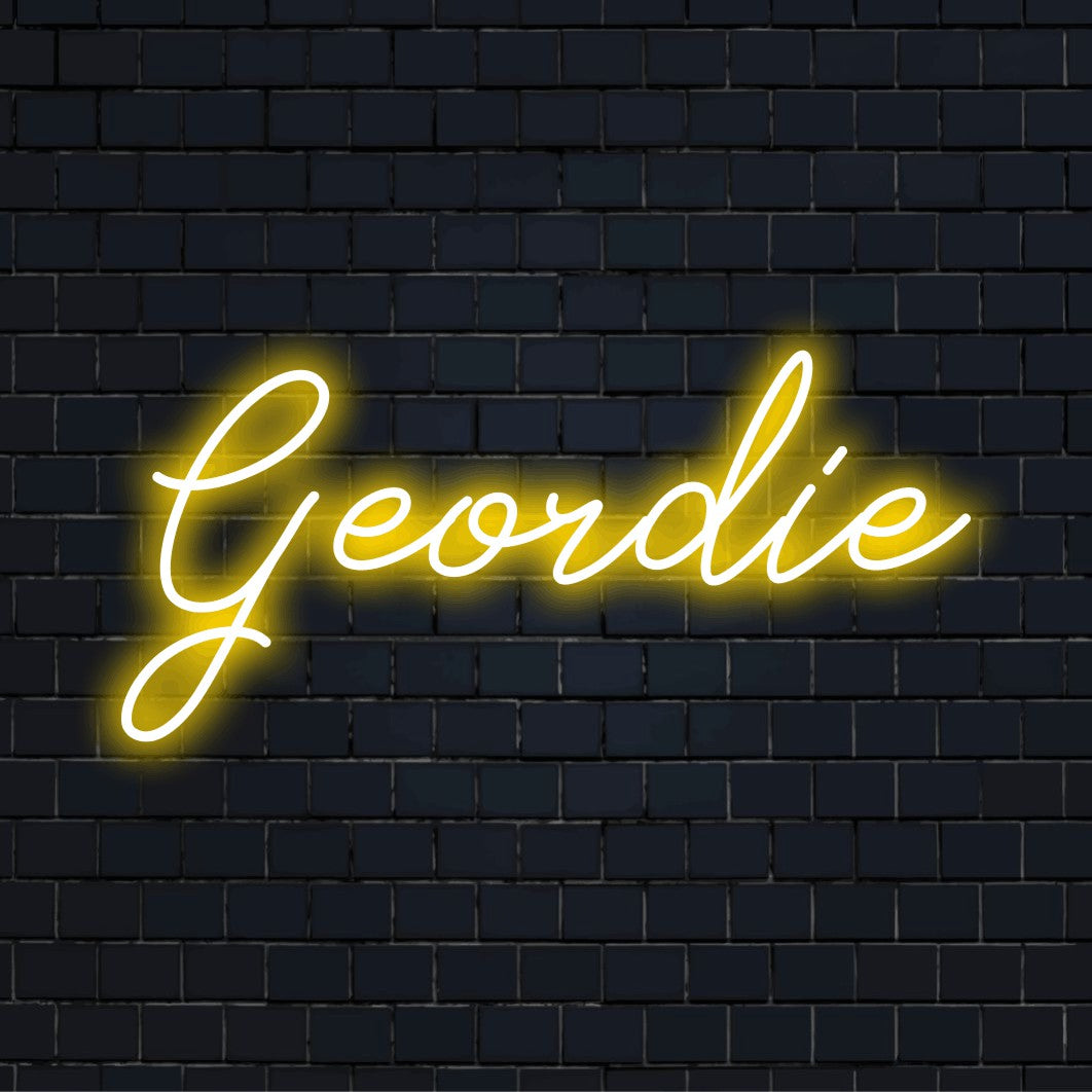 Geordie LED Neon Sign, bright neon lettering against black brick wall