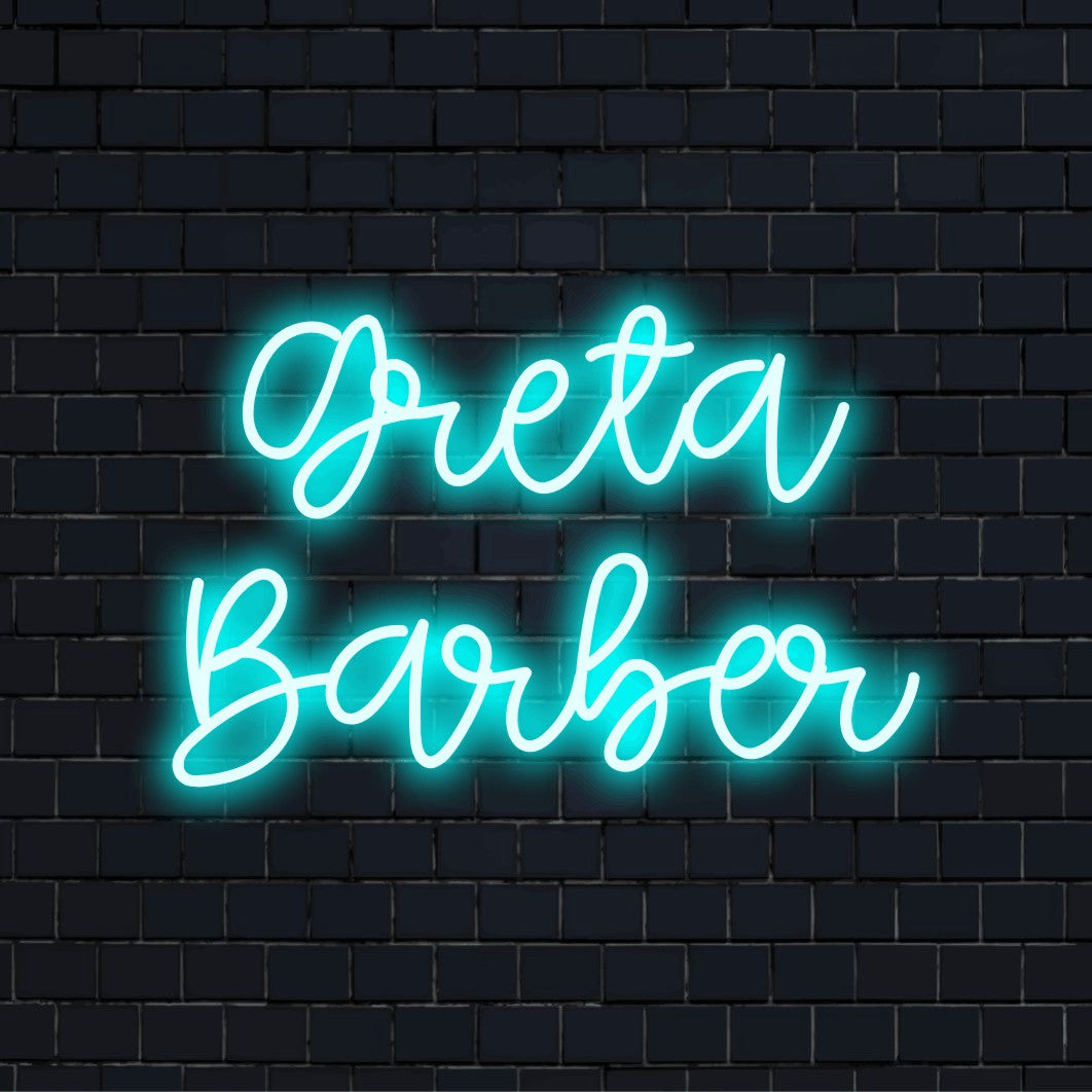 Greta Barber Personalized Neon Light with glowing lettering against brick backdrop