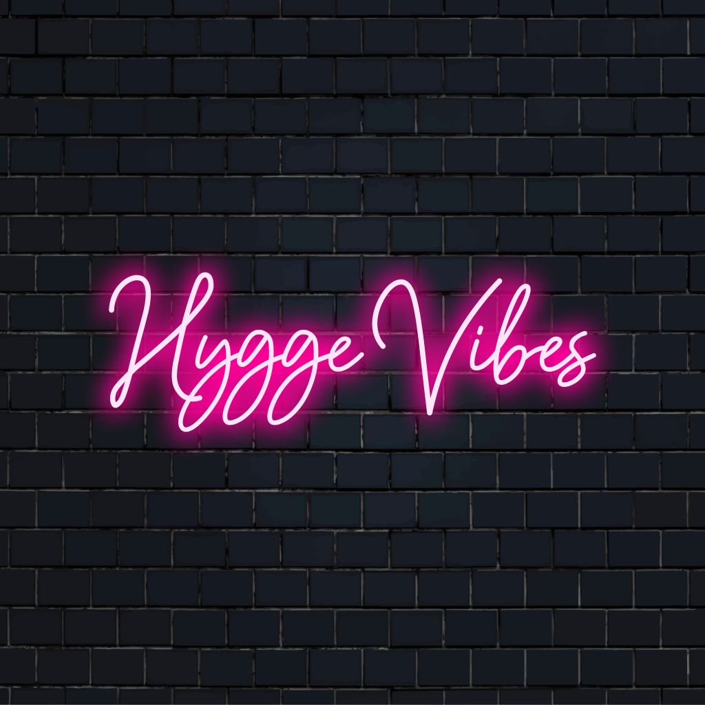 Hygge Vibes Neon Light with soft neon glow against black brick wall