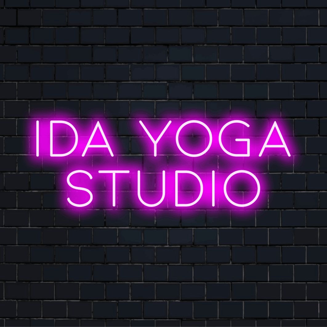 Ida Yoga Studio Custom Name Neon Sign, bright LED glow against brick backdrop