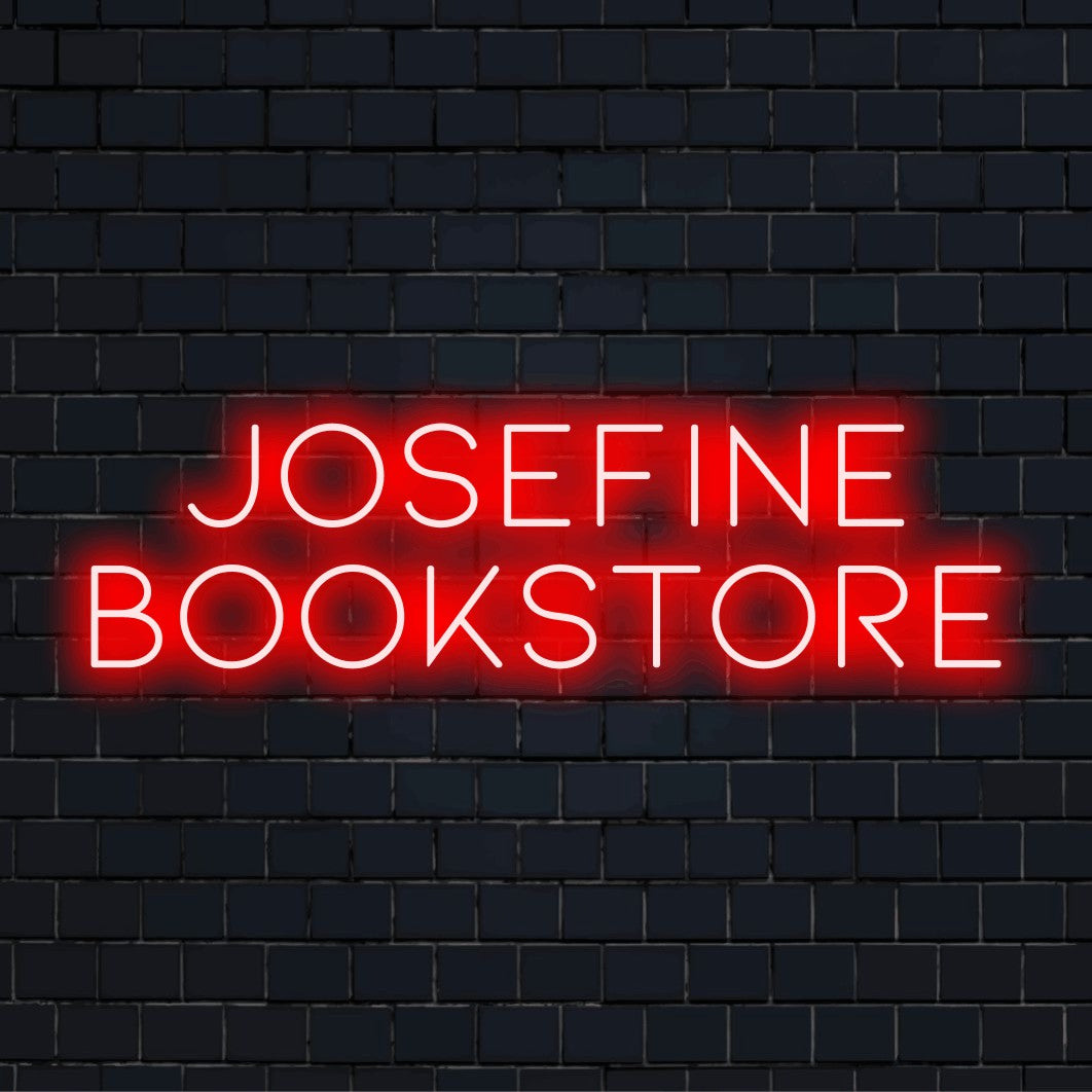 Josefine Bookstore Custom Name Neon Sign, glowing neon text on dark brick wall