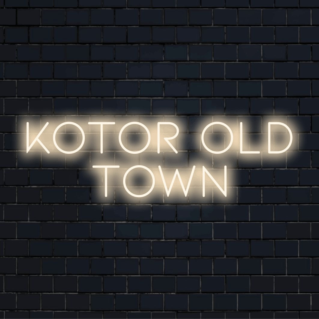 Kotor Old Town Neon Sign, glowing wall decor on dark brick background