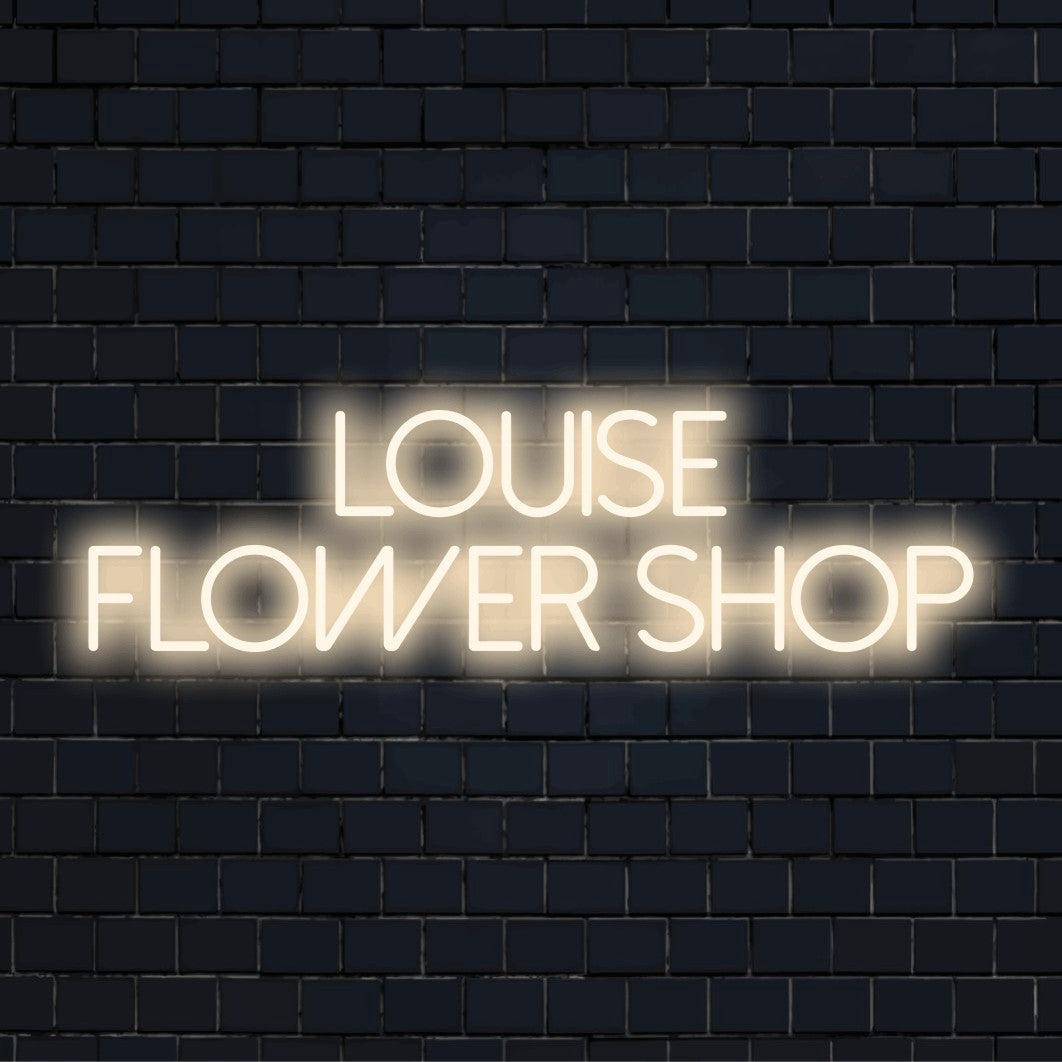 Louise Flower Shop Personalized Neon Light with bright neon lettering on black brick background