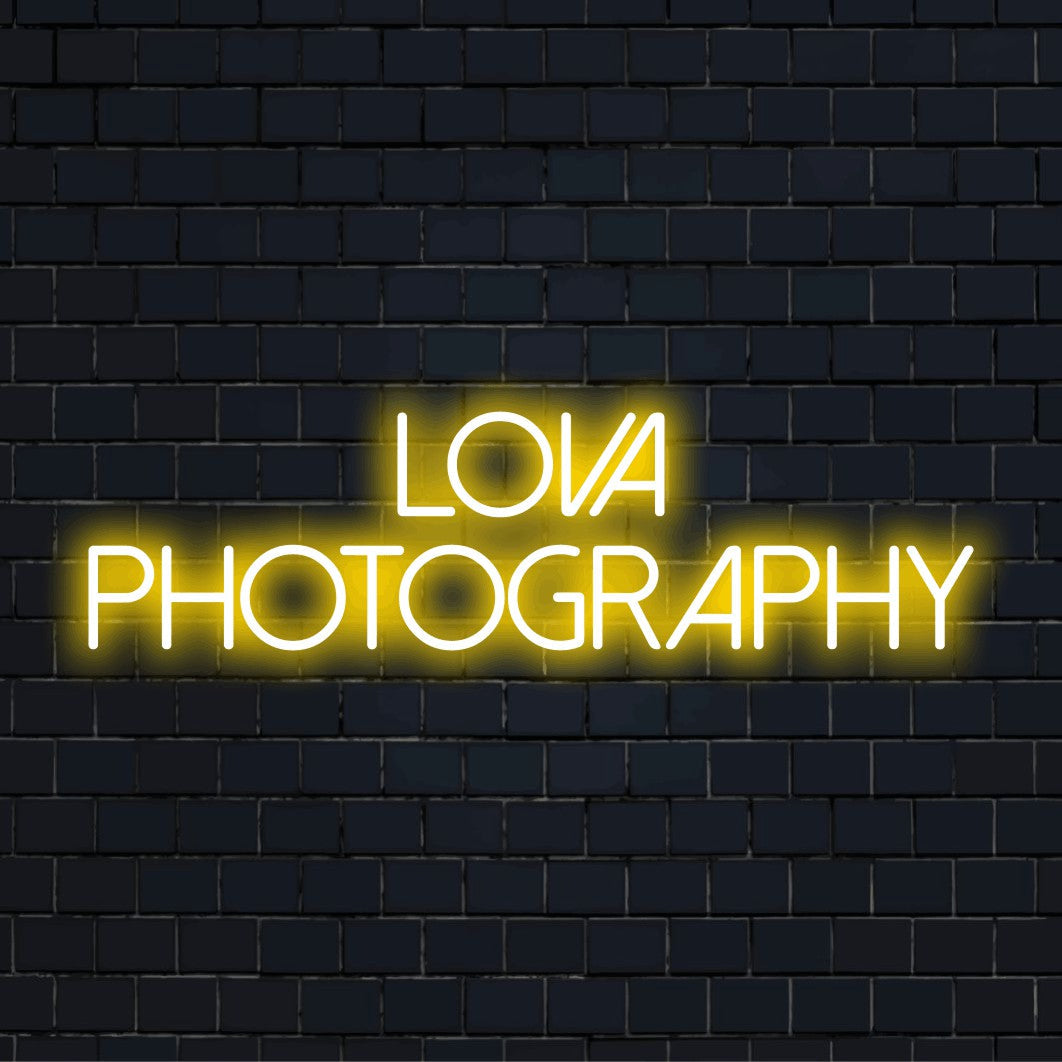 Lova Photography Personalized Neon Light with glowing neon text on dark brick wall