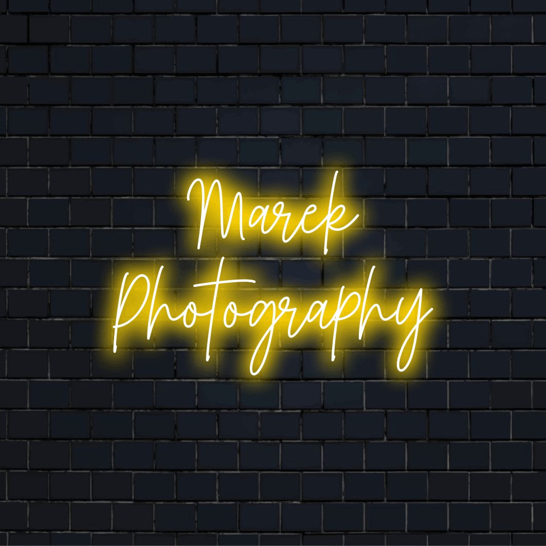 Marek Photography Custom Name Neon Sign, neon text light on dark brick wall