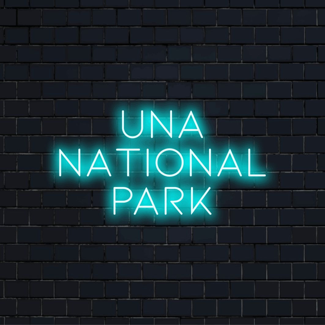 Una National Park Neon Light with bright neon lettering on dark brick background