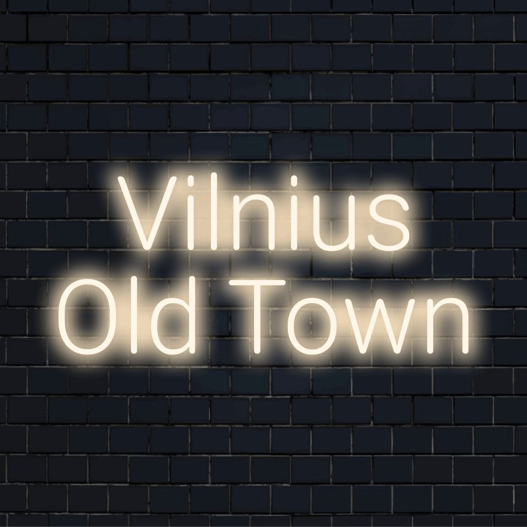 Vilnius Old Town Neon Sign, glowing lettering against black brick wall