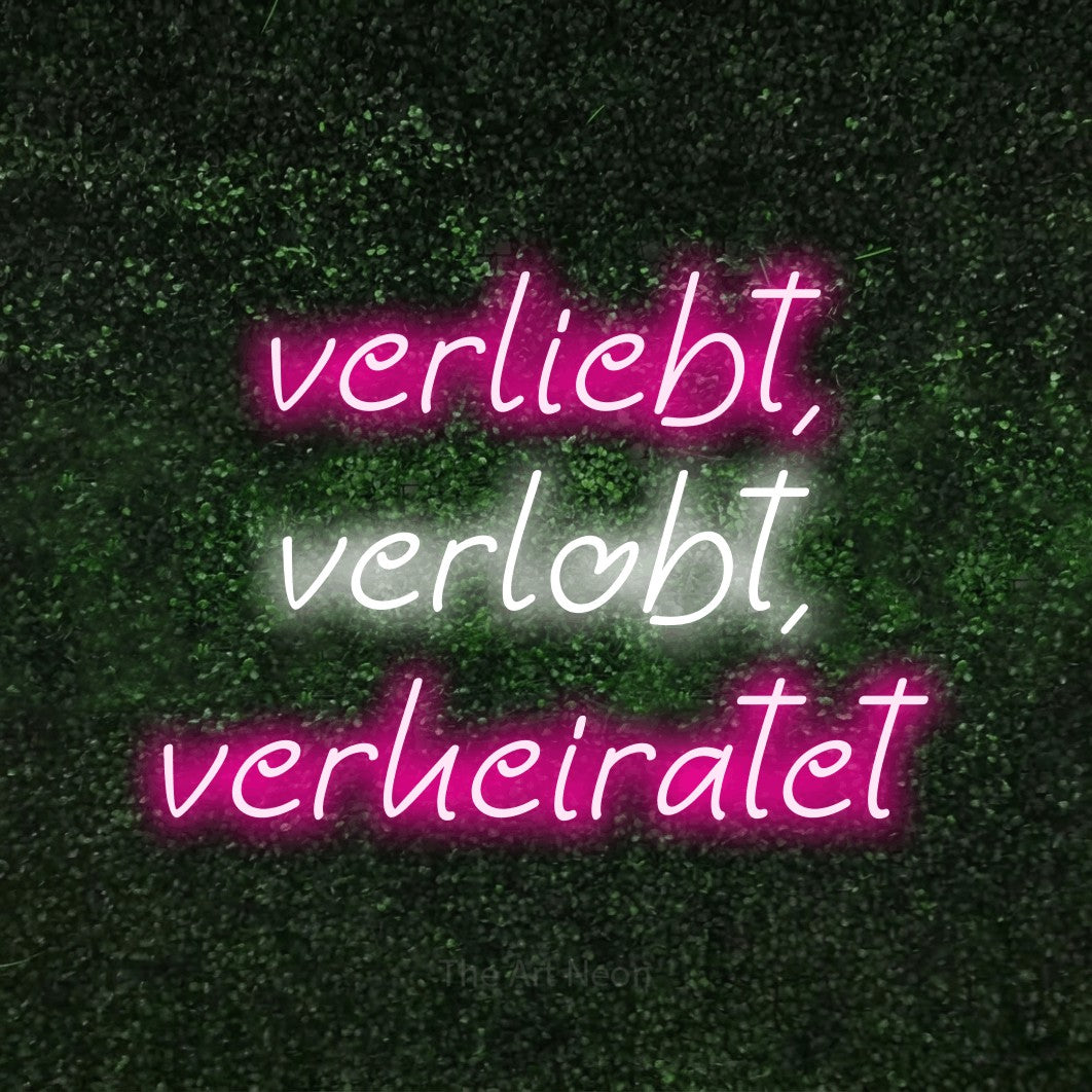 LED neon sign reading “verliebt, verlobt, verheiratet”, arranged in 3 lines.