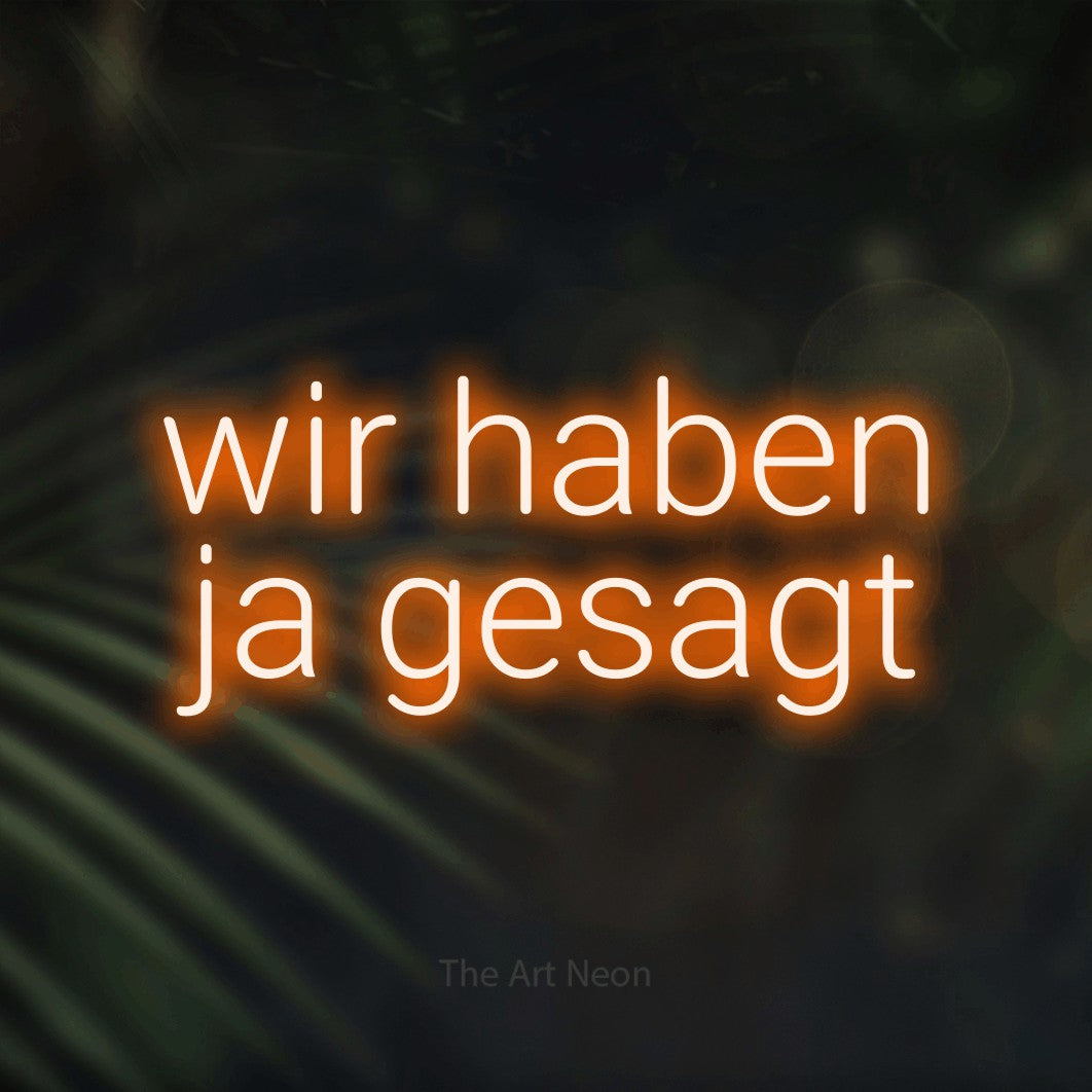 LED neon sign reading “wir haben ja gesagt”, arranged in 2 lines.