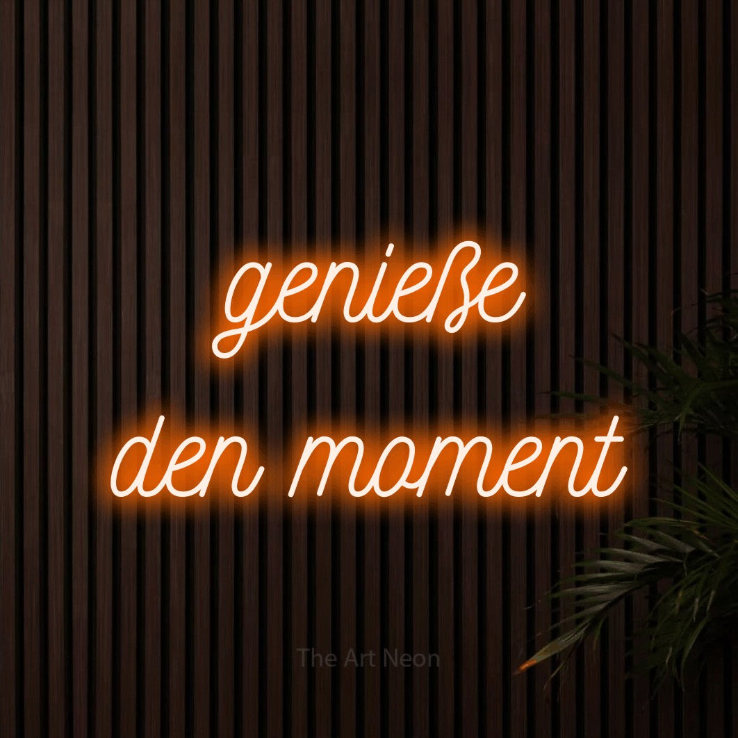 LED neon sign reading “genieße den moment”, arranged in 2 lines.