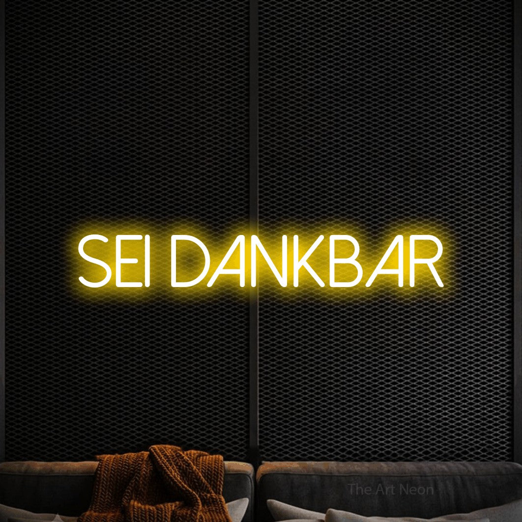 LED neon sign reading “sei dankbar”, arranged in a single line.