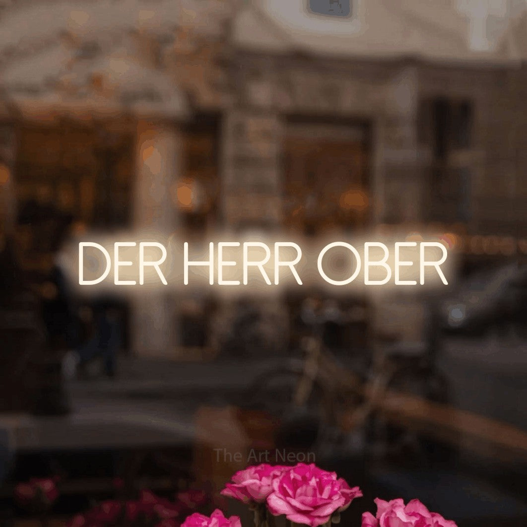 LED neon sign reading “der herr ober”, arranged in a single line.