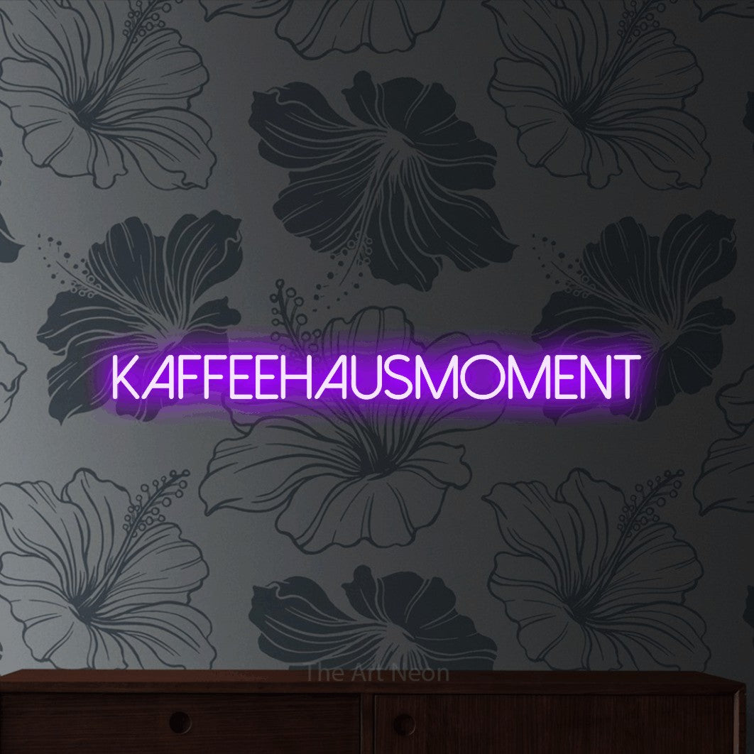 LED neon sign reading “kaffeehausmoment”, arranged in a single line.