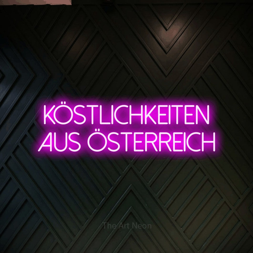 LED neon sign reading “köstlichkeiten aus österreich”, arranged in 2 lines.