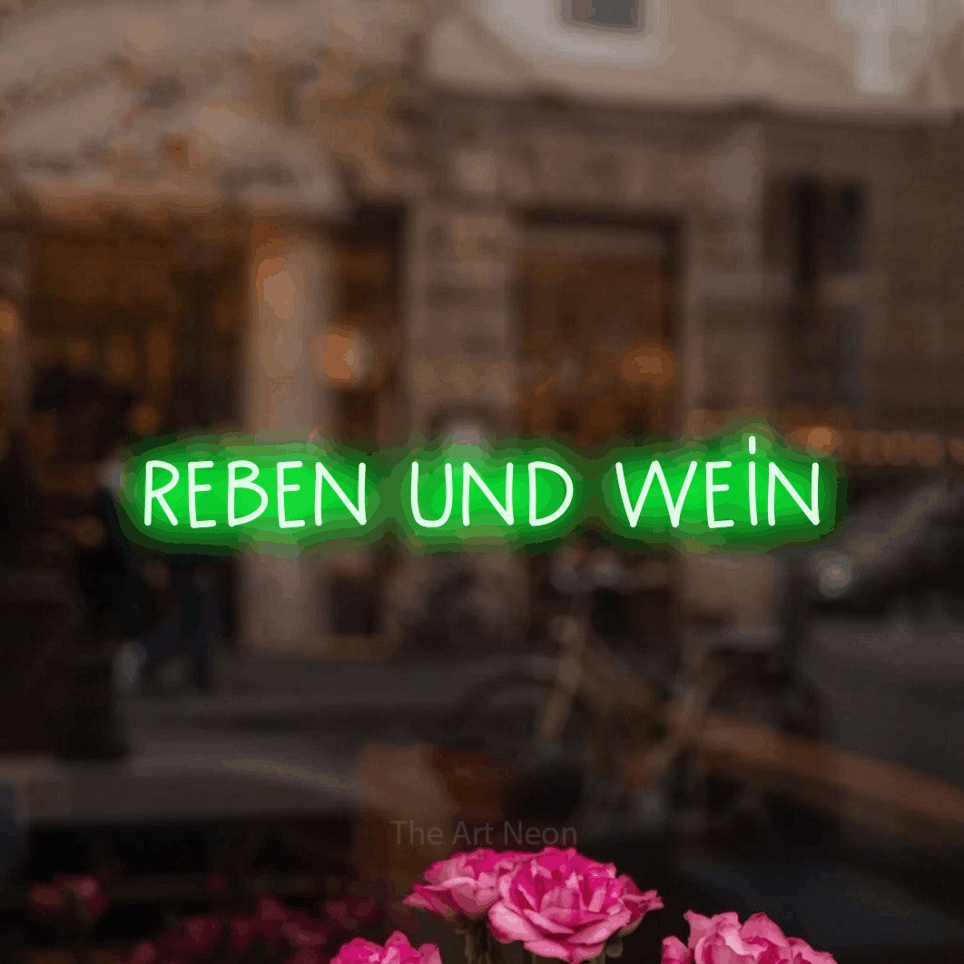 LED neon sign reading “reben und wein”, arranged in a single line.
