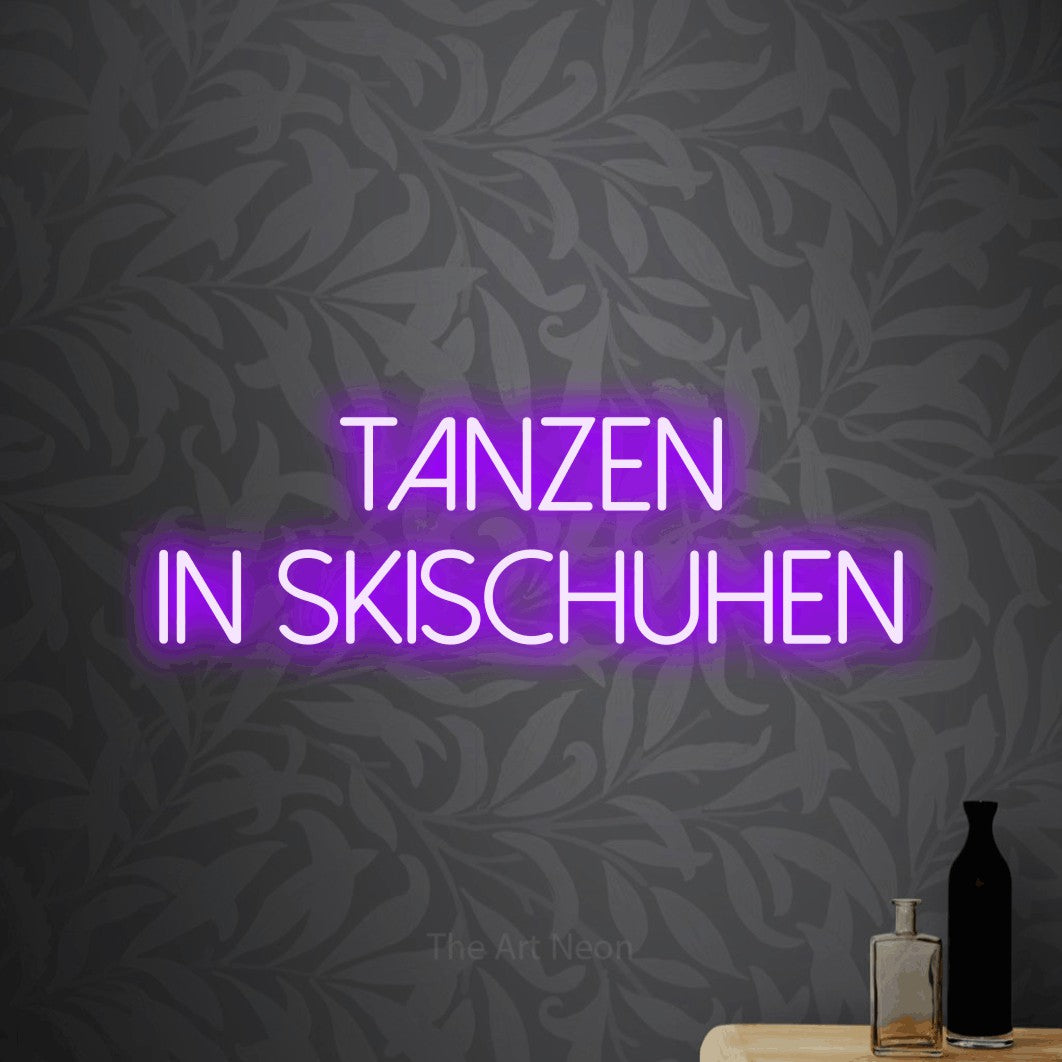 LED neon sign reading “tanzen in skischuhen”, arranged in 2 lines.