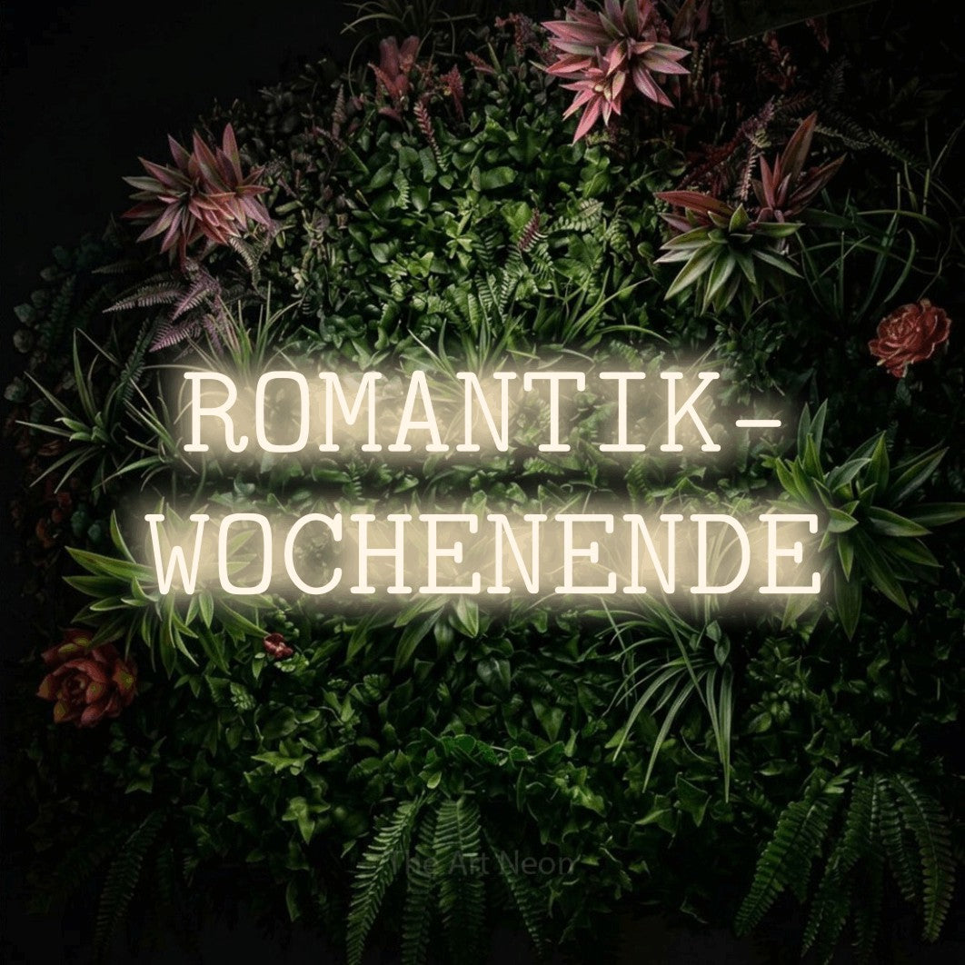 LED neon sign reading “ROMANTIK- WOCHENENDE”, arranged in 2 lines.
