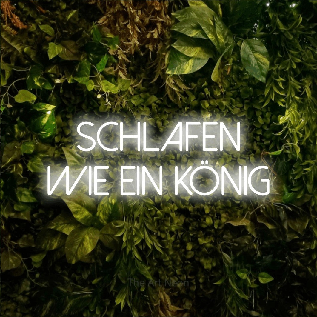 LED neon sign reading “schlafen wie ein könig”, arranged in 2 lines.