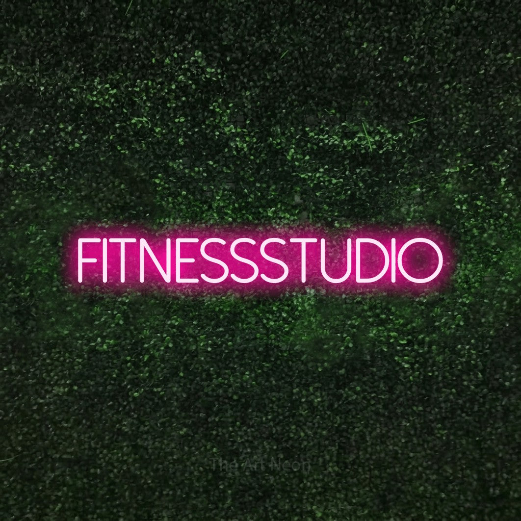 LED neon sign reading “FITNESSSTUDIO”, arranged in a single line.