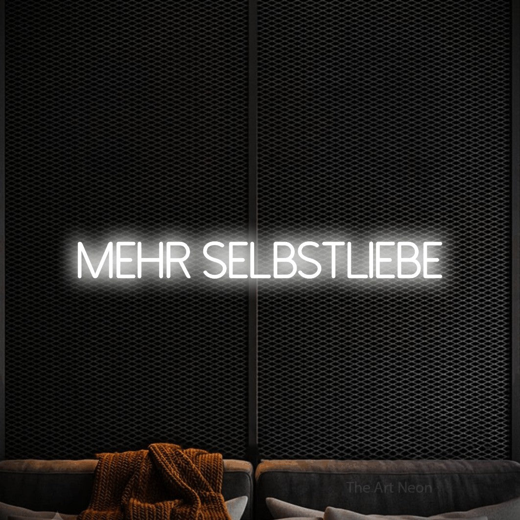 LED neon sign reading “Mehr Selbstliebe”, arranged in a single line.