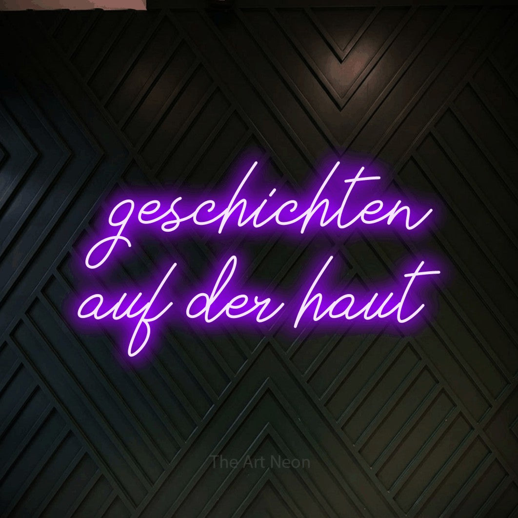LED neon sign reading “geschichten auf der haut”, arranged in 2 lines.