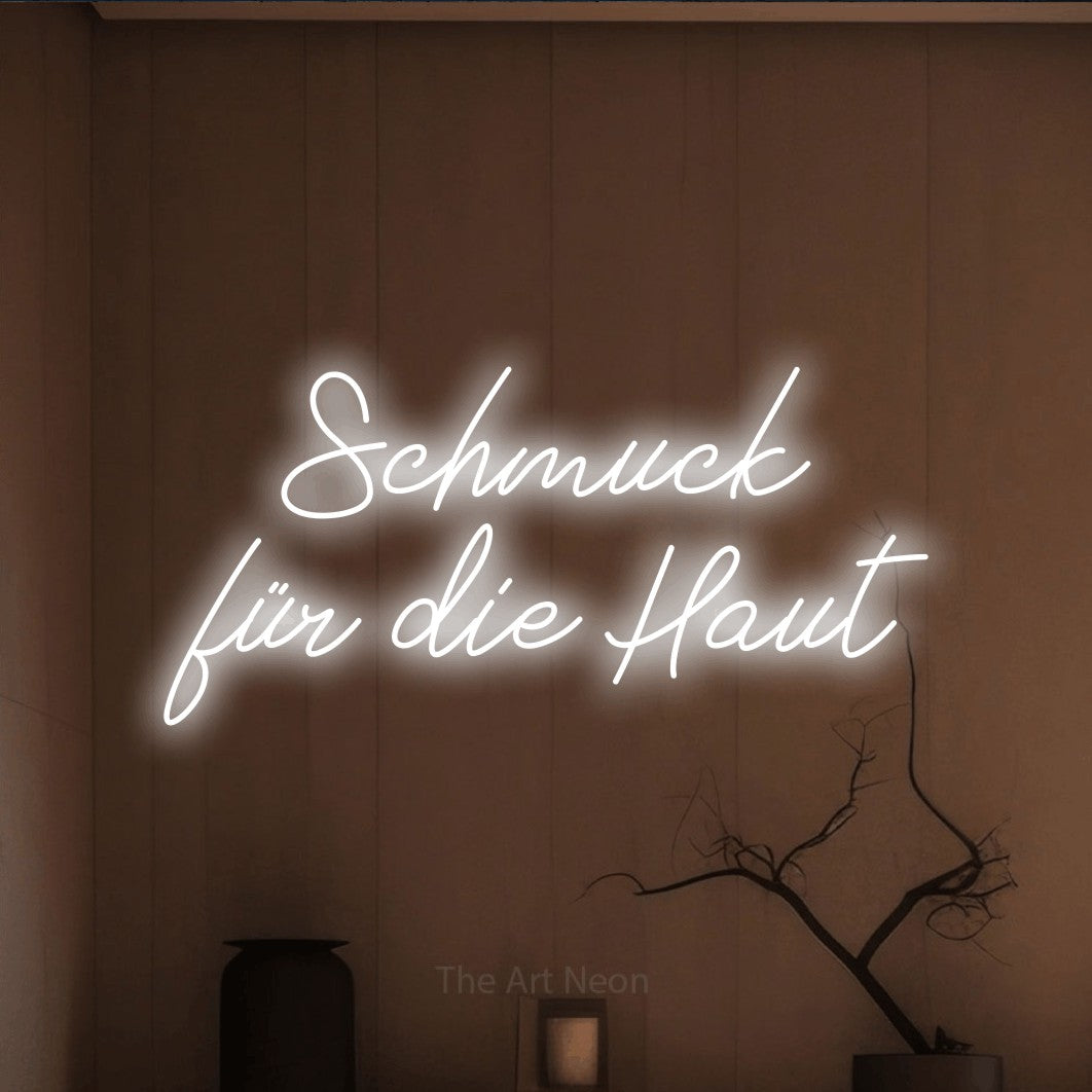 LED neon sign reading “Schmuck für die Haut”, arranged in 2 lines.