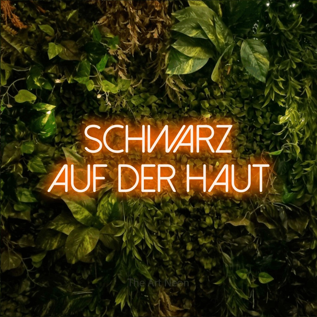 LED neon sign reading “Schwarz auf der Haut”, arranged in 2 lines.
