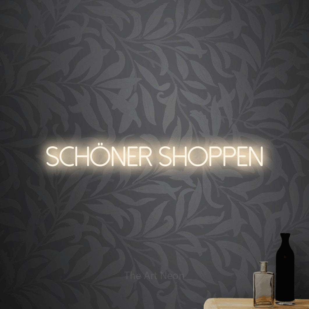 LED neon sign reading “Schöner shoppen”, arranged in a single line.