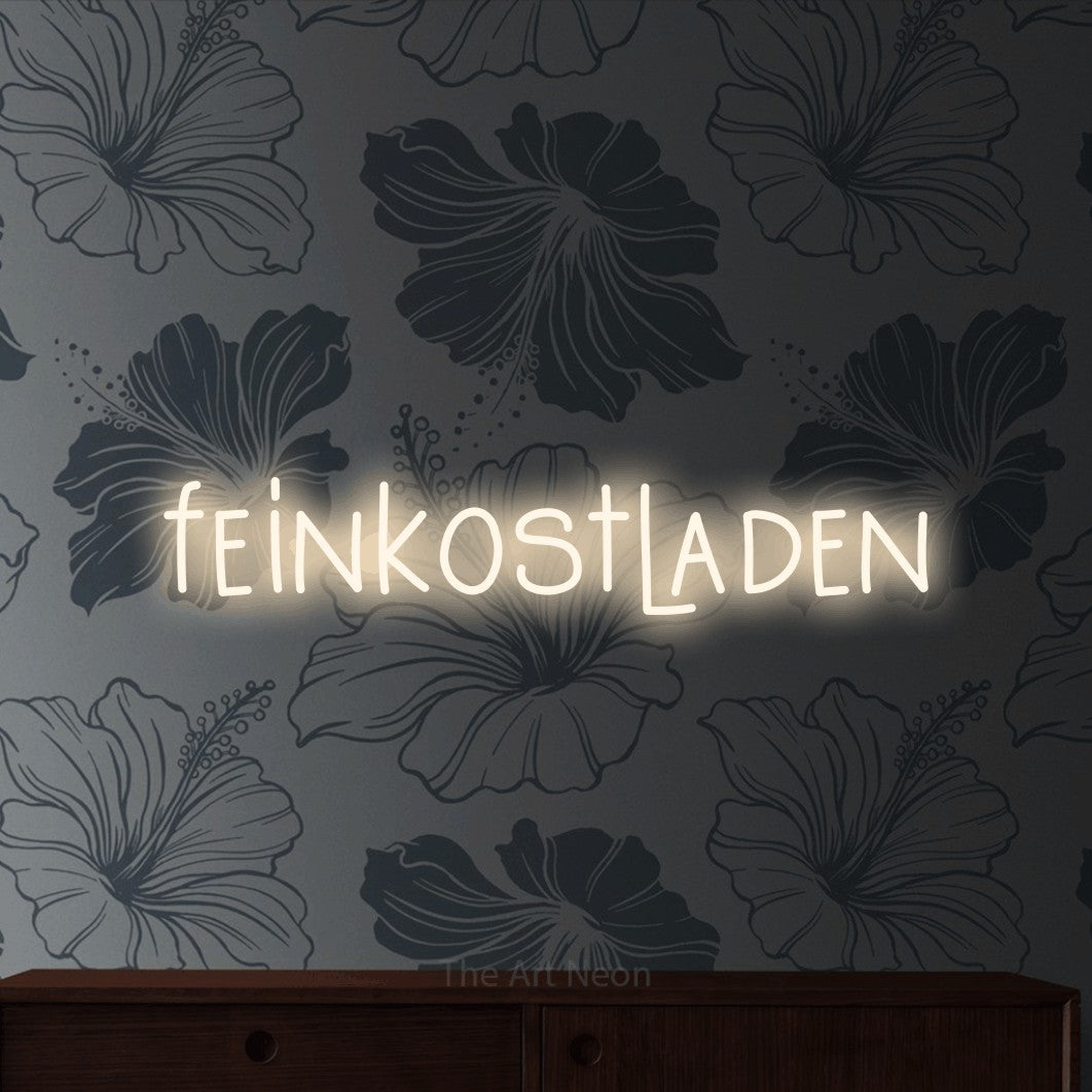 LED neon sign reading “feinkostladen”, arranged in a single line.