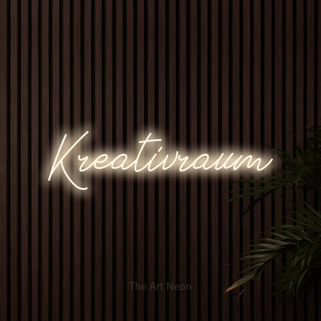 LED neon sign reading “Kreativraum”, arranged in a single line.