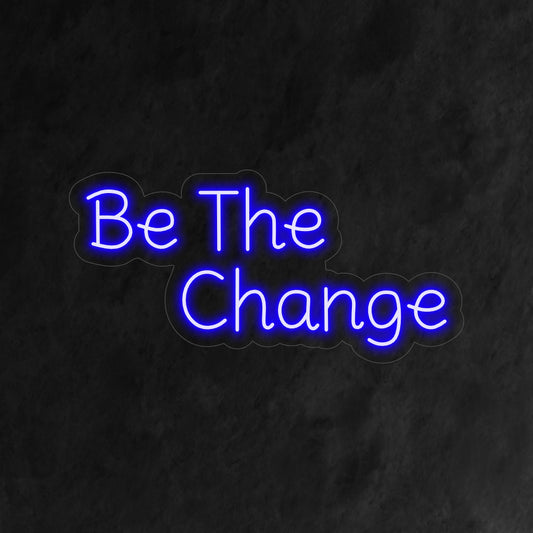 "Be the Change Neon Sign" - A powerful neon light featuring an inspiring message, infusing positivity and empowerment into your living space.