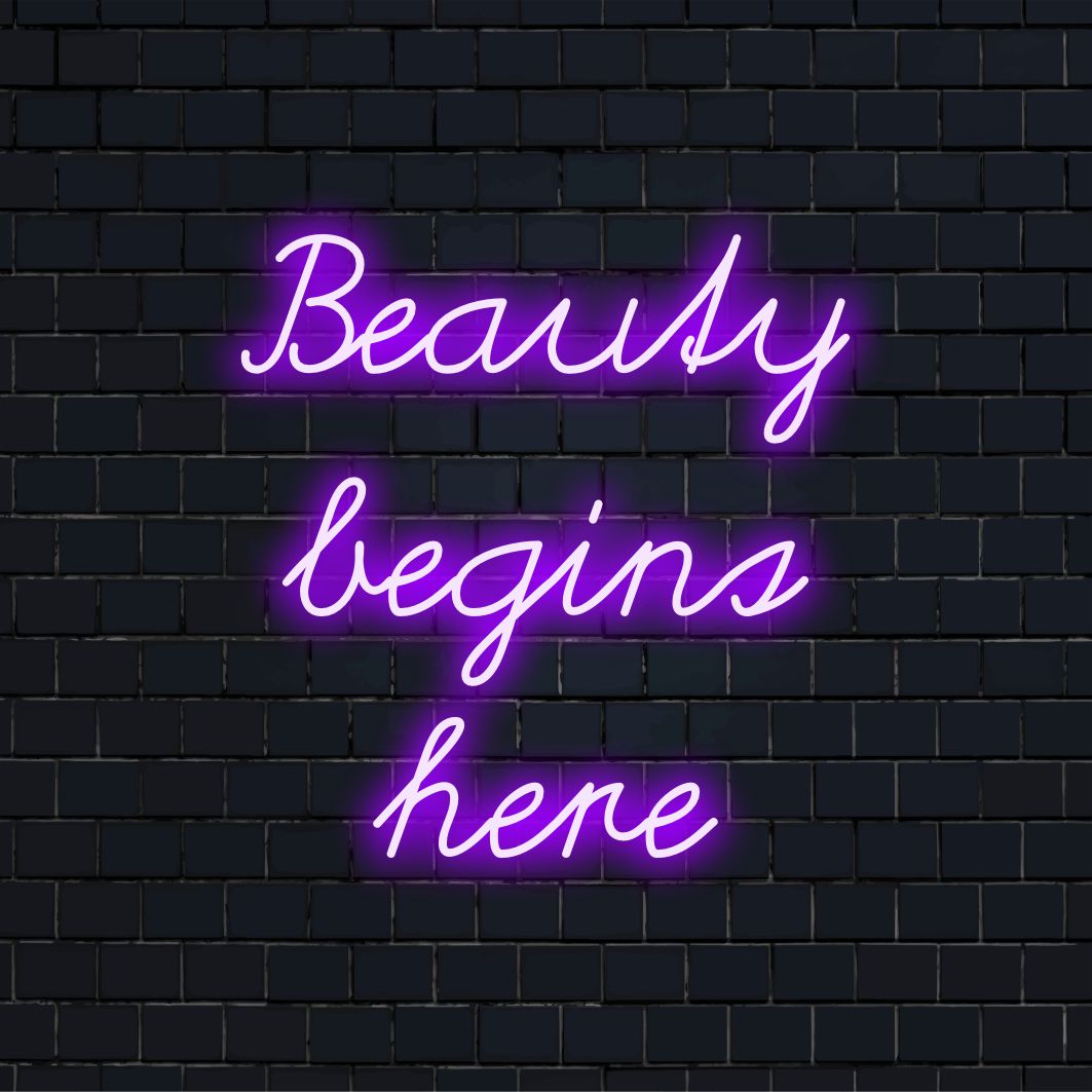 Mitmekülgne LED-neoonreklaamide lugemine Beauty Begins Here, mis ühendab neoontsitaadi ja kohandatud LED-disaini elemente.