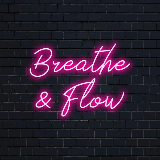 LED neon sign with the words Breathe And Flow, a calming and stylish wall decor for mindfulness spaces.