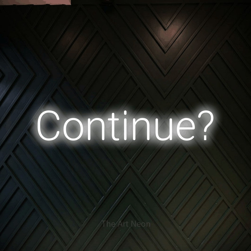 LED neon sign reading “Continue?”, arranged in a single line.