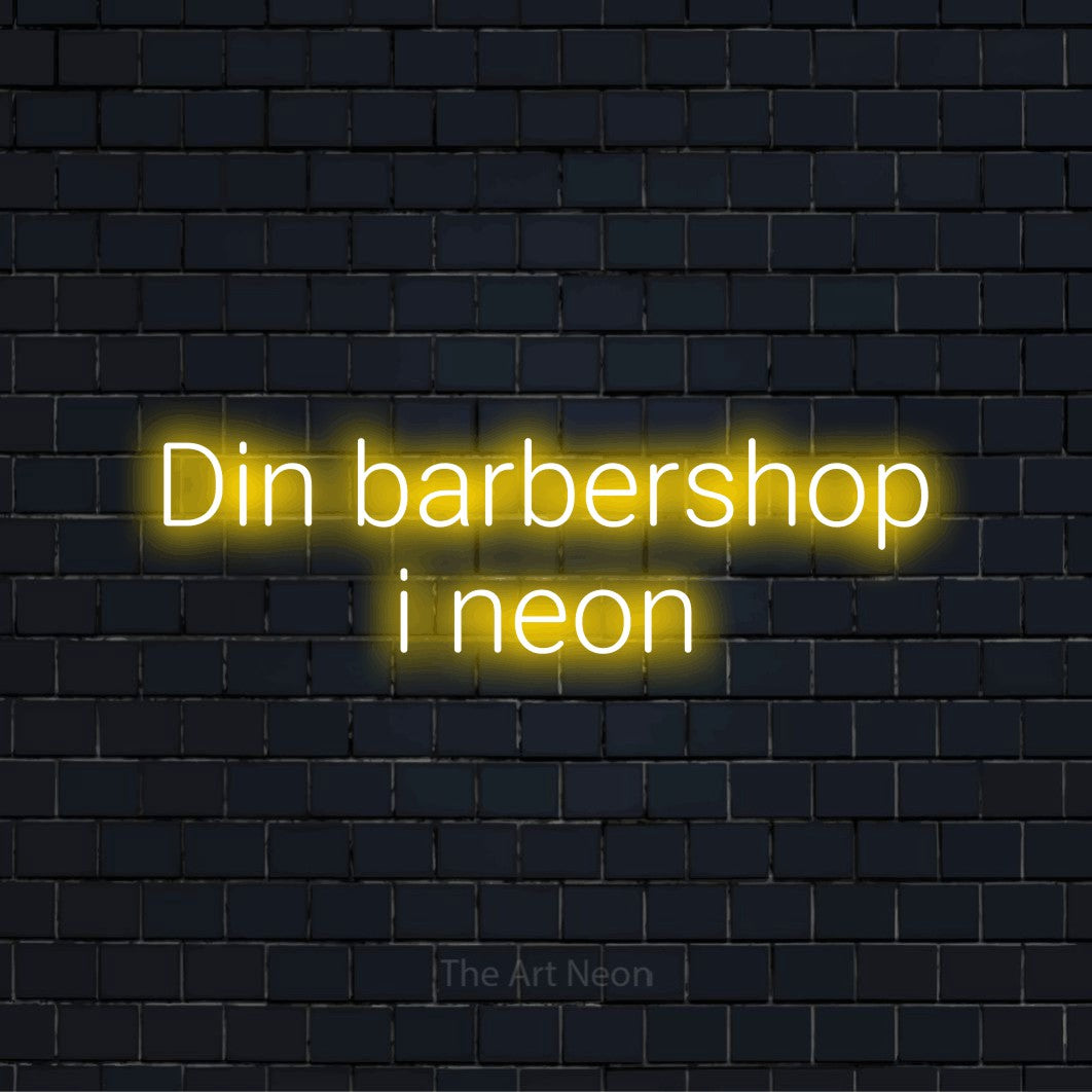 Personligt neonskilt med teksten “Din barbershop i neon” på en sort murstensvæg