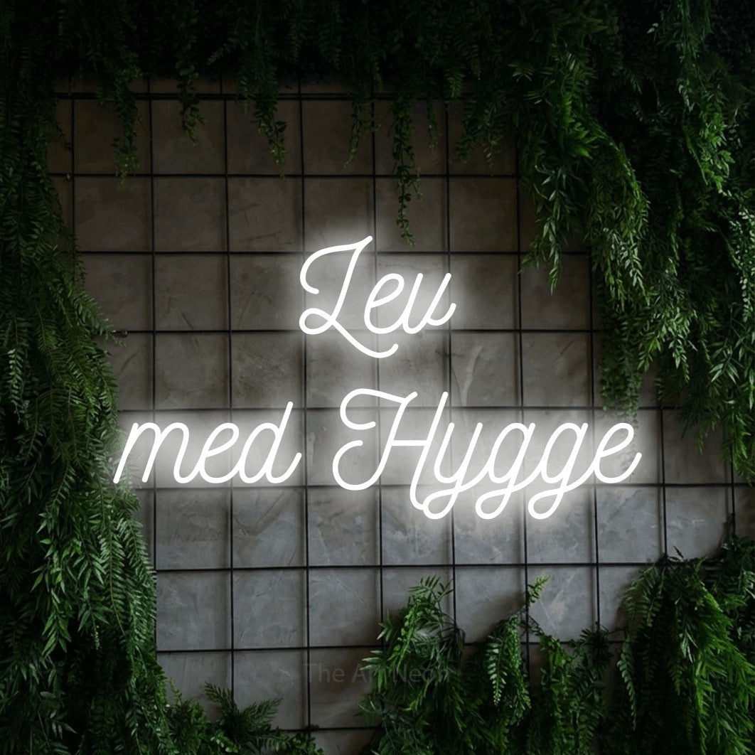 LED neon sign reading “Lev med Hygge”, arranged in 2 lines.